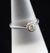 A 1920`s platinum and illusion set solitaire diamond ring, size O.