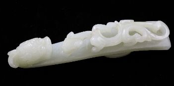 A Chinese pale celadon jade `dragon` belt hook, 18th / 19th century, carved in relief and openwork