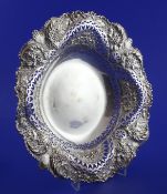 A late Victorian pierced and repousse silver circular fruit bowl, decorated with foliage and