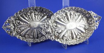 A pair of late Victorian embossed silver navette shaped dishes by Elkington & Co Ltd, with engraved