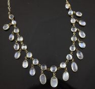 An early 20th century gold and moonstone drop fringe necklace, set with graduated oval and cabochon