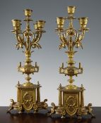 A pair of Louis XVI style ormolu candelabra, modelled as a two handled vase issuing five scrolling