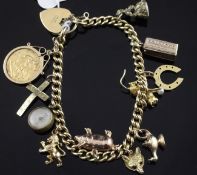 An 18ct gold curb link charm bracelet, with heart shaped padlock clasp and hung with eleven mainly