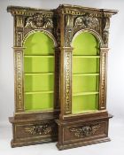 A pair of Italian Renaissance style walnut and parcel gilt wall niches, with inverted breakfront