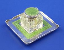 A late 19th century Viennese silver and green guilloche enamel mounted cut glass inkwell and stand