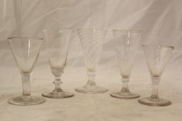 Five glass ale flutes, 18th century, two with wrythen twist stems and bowls, the other three with