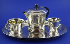 A 1920`s/1930`s Indian Art Deco silver three piece tea set and tray by Warner Brothers, Delhi, of