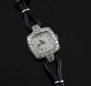 A lady`s platinum and diamond set manual wind wrist watch, with Roman dial and diamond set cushion
