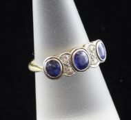 A 1940`s 18ct gold and platinum, sapphire and diamond half hoop ring, set with three graduated oval