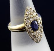 A late Victorian 18ct gold, sapphire and diamond marquise shaped ring, set with a central oval cut