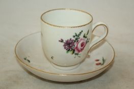A Chelsea-Derby coffee cup and saucer, painted with floral bouquets within gilt borders, gilt D and