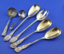 A pair of Victorian silver serving spoons and a matching sugar sifter, the cast handles decorated