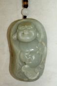 A Chinese celadon jade carving of Budai, 20th century, the figure above lingzhi fungus, the stone