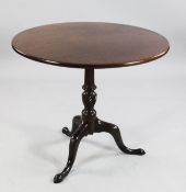 A George III mahogany circular tripod table, with central spiral twist column and downswept