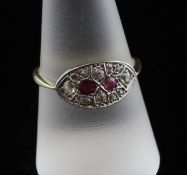 An Edwardian, gold ruby and diamond cluster ring, of curved navette form, size R.