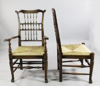 A set of eight rush seat spindle back dining chairs, two with arms, six singles, on tapering front