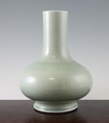 A Chinese celadon glazed bottle vase, 18th / 19th century, the shoulder incised with bats amid