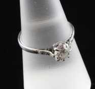A white gold and single stone diamond ring, with diamond set shoulders, the central stone weighing