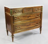 A French Directoire mahogany and brass mounted marble top commode, fitted three long drawers