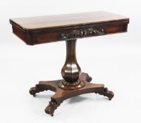 A William IV mahogany folding card table, with acanthus scroll decorated frieze, on octagonal pear