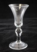 A baluster wine glass, c.1730, the bell shaped bowl above an inverted baluster stem, 16cm.