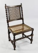 A 17th century walnut chair, with caned back and seat and barley twist uprights