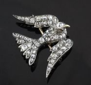 An Edwardian gold and diamond encrusted brooch, modelled as a bird, set with old cut diamonds and