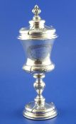 A late 18th/ early 19th century German silver chalice and cover, of vase form, with engraved