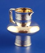 A 19th century Russian 84 zolotnik silver cream jug, with ovoid girdle and reeded neck and base,
