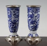 A pair of Chinese blue and white beaker vases, Kangxi period, each painted with panels of flowers