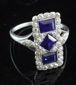 An Art Deco platinum, millegrain set sapphire and diamond triple cluster tablet ring, of