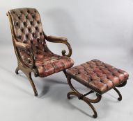 A Victorian mahogany open armchair, upholstered in faded red buttoned leather, with scroll arms and