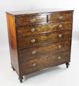 A large George III mahogany chest, of two short and four long graduated drawers with oval brass