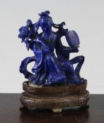 A Chinese lapis lazuli seated figure of a flower fairy, Republic period, holding a peony sprig and