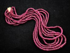 A multi strand facet cut ruby bead necklace, with gold clasp, 20.5in.