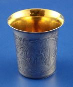 A mid 19th century Russian 84 zolotnik silver beaker, engraved with townscape panels amongst