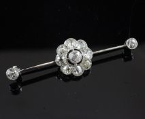 A white gold and diamond cluster bar brooch, with eleven millegrain set old cut diamonds, 2in.