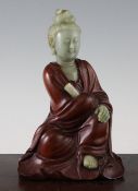 A Chinese rosewood and celadon jade seated figure of Guanyin, her head, her scroll, her left hand