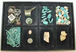 A tray of Egyptian and Roman artefacts, including scarab beetles, turquoise glazed amulets and