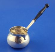 A George II silver brandy saucepan, with engraved armorial and turned wooden handle, indistinct