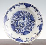A Delft blue and white dish, 18th century, painted to the centre with a horse on adotted ground,