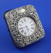 A late Victorian repousse silver mounted leather travelling watch case containing a nickel cased 8-