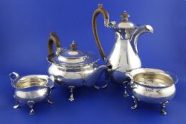 A George V silver four piece tea set, of squat circular form, with cut rims, on pad feet, Charles