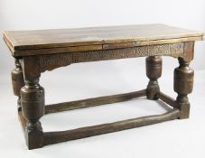 A 17th century design oak draw leaf table, on bulbous cup and cover supports united by ground