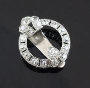 A 1940`s white gold and diamond set lapel clip, of open circular form, set with eighteen millegrain