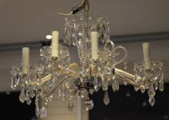A George III style cut glass eight branch chandelier, with prismatic lustre drops and central vase