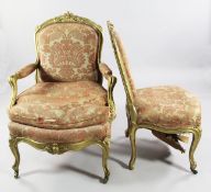 A pair of Louis XV style carved giltwood fauteuils, with serpentine seats and scroll legs, together