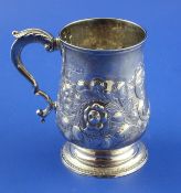 A George III silver mug by Peter and William Bateman, of baluster form, with later embossed
