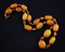 A single strand amber bead necklace, with gilt metal clasp (string detached), and mounted with