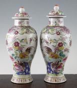 A pair of Chinese famille rose baluster vases and covers, 19th century, each painted with chickens